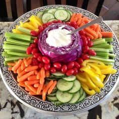 a platter filled with vegetables and dip