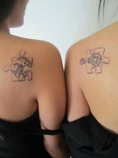 two women with matching tattoos on their backs