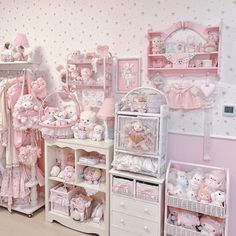 a room filled with lots of pink teddy bears and baby cribs in it