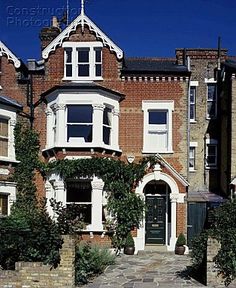 an old brick house with ivy growing on it