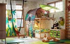 a child's bedroom decorated in green and yellow with jungle animals on the walls