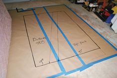 the floor is being laid out with blue tape