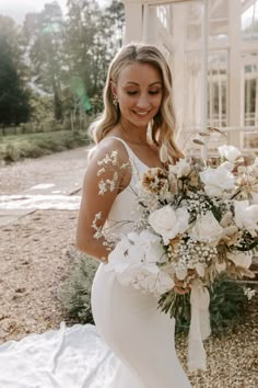 a woman in a wedding dress holding a bouquet