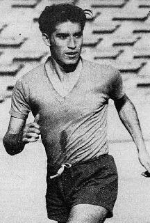 an old photo of a man running on the field