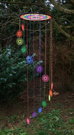 a multicolored wind chime hanging from a tree