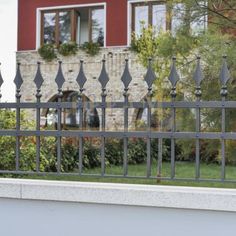 an iron fence is in front of a house