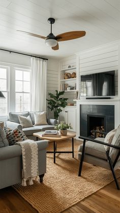 a living room filled with furniture and a fire place