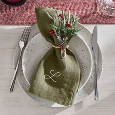 a place setting with napkins and silverware