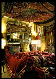 a bed sitting under a canopy in a bedroom