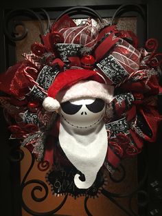 a wreath with a skeleton wearing a santa hat