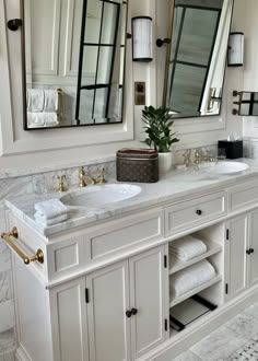 a bathroom with two sinks and mirrors in it