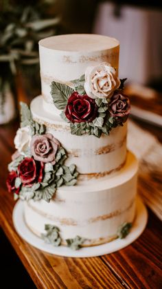 a three tiered cake with flowers on it