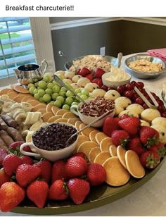 a large platter filled with lots of different types of fruit and crackers on top of a table