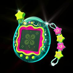 an electronic toy with stars and shapes on it's display screen, in the dark