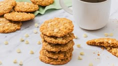 a stack of cookies next to a cup of coffee