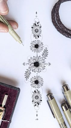 a pen and some pens on top of a paper with an image of sunflowers