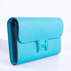 Despite its status as an extraordinary symbol of luxury, the allure of the Constance Long Wallet extends beyond its exclusivity. Resplendent in Blue Paon Epsom leather, this wallet exudes a rich hue that elevates it above traditional colors. Hermès, revered for its tradition of excellence, crafts this piece with meticulous attention to detail, featuring the iconic "H" clasp in striking gold. Palladium-tone hardware complements the clasp, adding a sleek appeal. The intelligently designed interior Elegant Blue Wallets, Elegant Evening Blue Wallets, Elegant Blue Evening Wallets, Blue Rectangular Wallets For Formal Occasions, Luxury Blue Wallet For Formal Occasions, Luxury Clutch Wallet For Formal Occasions, Luxury Formal Clutch Wallet, Formal Blue Rectangular Wallets, Designer Blue Wallet For Formal Occasions