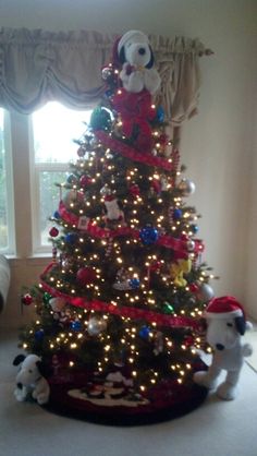 a christmas tree decorated with lights and stuffed animals