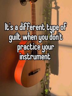 a guitar hanging on the wall next to a potted plant that says it's a different type of guilt when you don't practice your instrument