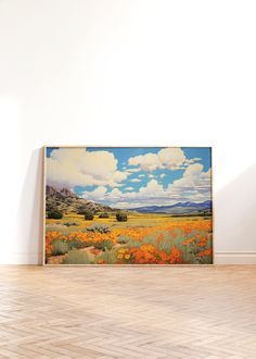 an empty room with a large painting on the wall and hard wood flooring in front of it