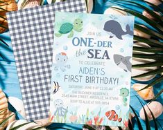 an ocean themed birthday party with blue and white checkered table cloth, gingham napkin