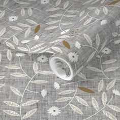 a grey and white wallpaper with gold leaf designs on the fabric, it is very soft