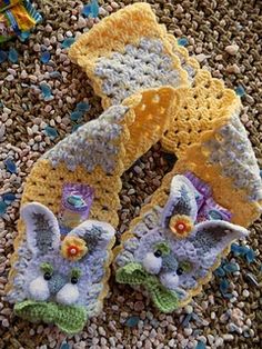 two crocheted animal slippers are laying on the ground