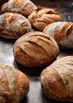 several loaves of bread sitting on top of a table