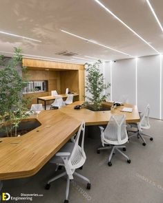 an office with white chairs and wooden desks