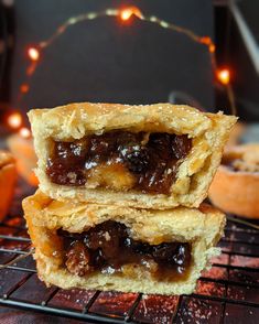 two pastries sitting on top of a cooling rack next to each other with lights in the background