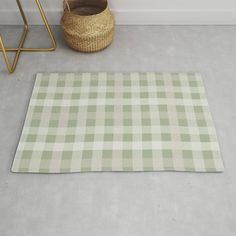 a green and white checkered rug next to a basket