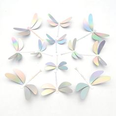 a bunch of small metal butterflies on a white background