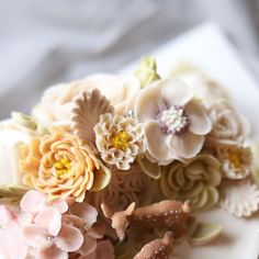 a white plate topped with flowers and deer figurines