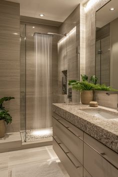 a bathroom with a sink, shower and plants in the corner on the counter top