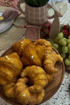 some croissants and grapes on a plate