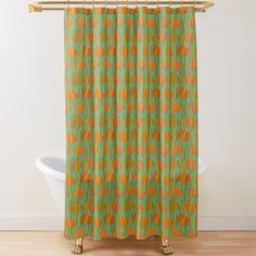 an orange and green shower curtain hanging on a wall next to a white bathtub