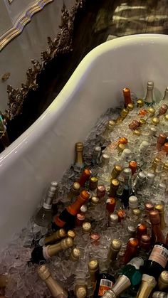 a bath tub filled with lots of bottles