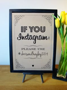 a vase filled with yellow tulips next to a sign that says if you instagram please use