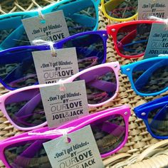 colorful sunglasses for sale at the market with price tags attached to their frames and labels on them