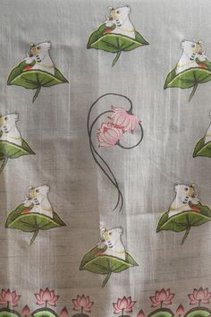 an embroidered fabric with flowers and cats on it's side, in front of a white background