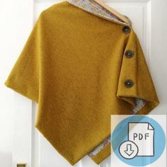 a yellow sweater hanging on a white door