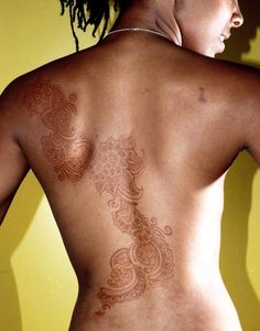 a woman with tattoos on her back