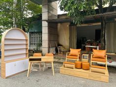 some chairs and tables are outside in front of a building