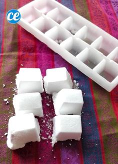 there are several pieces of marshmallow on the table next to an ice tray