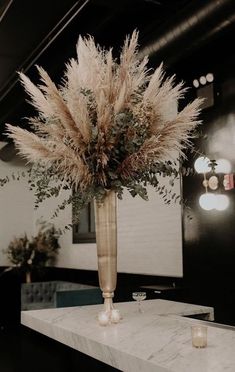 an instagram photo with a vase full of flowers and candles on the counter top