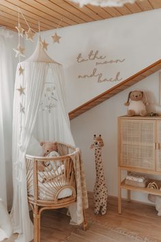 a baby's room is decorated in white and beige with stars on the ceiling