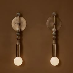 two light fixtures on a brown wall