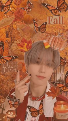 a young man holding a candle in front of a collage of butterflies and pumpkins