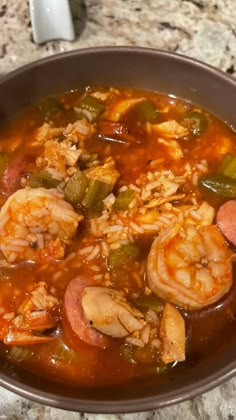 a bowl filled with shrimp and vegetables on top of a table