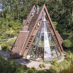 an unusual house in the middle of some trees